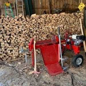 gas powered log splitter with stacked wood